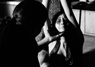 Amellya in a dark bondage scene