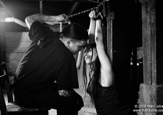 Amellya in a dark bondage scene